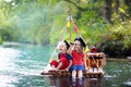 Kids playing pirate adventure on wooden raft Royalty Free Stock Photo