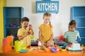 Kids playing with plastic food at daycare. Royalty Free Stock Photo