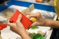 Kids playing plastic mold toys with sand on sandbox. Royalty Free Stock Photo