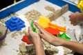 Kids playing plastic mold toys with sand on sandbox. Royalty Free Stock Photo