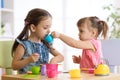 Kids playing with plastic tableware Royalty Free Stock Photo