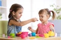 Kids playing with plastic tableware Royalty Free Stock Photo