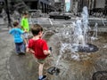 Kids playing in a public fountain in Louisville Kentucky