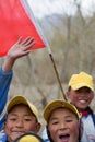 Kids playing with a red chinese flag