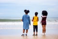 Kids playing running on sand at the beach, A group of children holding hands in a row on the beach in summer, rear view against Royalty Free Stock Photo