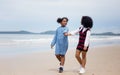 Kids playing running on sand at the beach, A group of children holding hands in a row on the beach in summer, rear view against Royalty Free Stock Photo