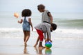 Kids playing running on sand at the beach, A group of children holding hands in a row on the beach in summer, rear view against Royalty Free Stock Photo