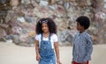 Kids playing running on sand at the beach, A group of children holding hands in a row on the beach in summer, rear view against Royalty Free Stock Photo