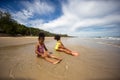 Kids playing running on sand at the beach, A group of children holding hands in a row on the beach in summer, rear view against Royalty Free Stock Photo