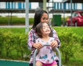 Kids playing at the see-saw in the playground. Siblings play together