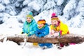 Kids playing in snow. Children play outdoors in winter snowfall. Royalty Free Stock Photo