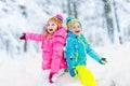Kids playing in snow. Children play outdoors in winter snowfall. Royalty Free Stock Photo