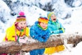 Kids playing in snow. Children play outdoors in winter snowfall.