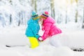 Kids playing in snow. Children play outdoors in winter snowfall. Royalty Free Stock Photo