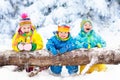 Kids playing in snow. Children play outdoors in winter snowfall. Royalty Free Stock Photo