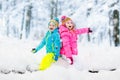 Kids playing in snow. Children play outdoors in winter snowfall. Royalty Free Stock Photo