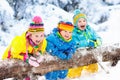 Kids playing in snow. Children play outdoors in winter snowfall. Royalty Free Stock Photo