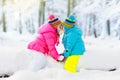 Kids playing in snow. Children play outdoors in winter snowfall. Royalty Free Stock Photo