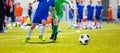 Kids Playing a Soccer Game. Young Boys Kicking Football Soccer Royalty Free Stock Photo