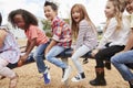 Kids playing on a spinning carousel in their schoolyard Royalty Free Stock Photo