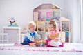 Kids playing with stuffed animals and doll house Royalty Free Stock Photo