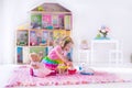 Kids playing with stuffed animals and doll house Royalty Free Stock Photo