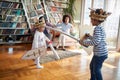 Kids playing with swords while parents cheering. Family, together, love, playtime