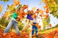 Kids playing with thrown leaves in the forest Royalty Free Stock Photo