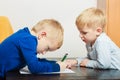 Kids playing together, drawing pictures on paper Royalty Free Stock Photo