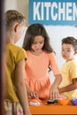 Kids playing in toy kitchen. Royalty Free Stock Photo