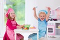 Kids playing with toy kitchen Royalty Free Stock Photo