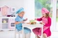 Kids playing with toy kitchen Royalty Free Stock Photo