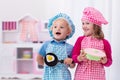 Kids playing with toy kitchen Royalty Free Stock Photo