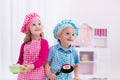 Kids playing with toy kitchen Royalty Free Stock Photo