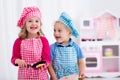 Kids playing with toy kitchen Royalty Free Stock Photo