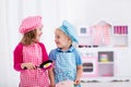 Kids playing with toy kitchen Royalty Free Stock Photo