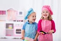 Kids playing with toy kitchen Royalty Free Stock Photo