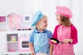 Kids playing with toy kitchen Royalty Free Stock Photo