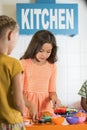 Kids playing at toy kitchen at playroom. Royalty Free Stock Photo