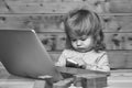 Kids playing with toys. Small boy with computer and phone Royalty Free Stock Photo