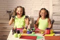 Kids playing with toys. Girls painters painting with gouache paints on table