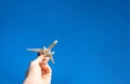 Kids playing toys in sun light day. White plane in hand fly in blue sunlight sky. Airplane, aircraft flight on air bright Royalty Free Stock Photo