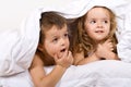 Kids playing under the quilt in bed Royalty Free Stock Photo