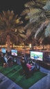 Kids playing video games outdoor, Oman