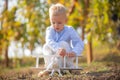 Kids playing with vintage wooden airplane outdoors. Kids having fun with toy airplane in field against nature background Royalty Free Stock Photo