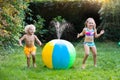 Kids playing with water ball toy sprinkler Royalty Free Stock Photo