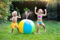 Kids playing with water ball toy sprinkler Royalty Free Stock Photo