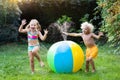 Kids playing with water ball toy sprinkler Royalty Free Stock Photo