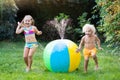 Kids playing with water ball toy sprinkler Royalty Free Stock Photo