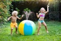 Kids playing with water ball toy sprinkler Royalty Free Stock Photo